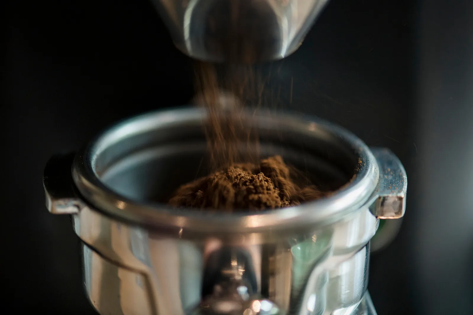 Freshly ground coffee falling into a portafilter